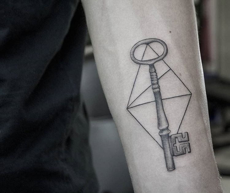 Key tattoo on the arm for men