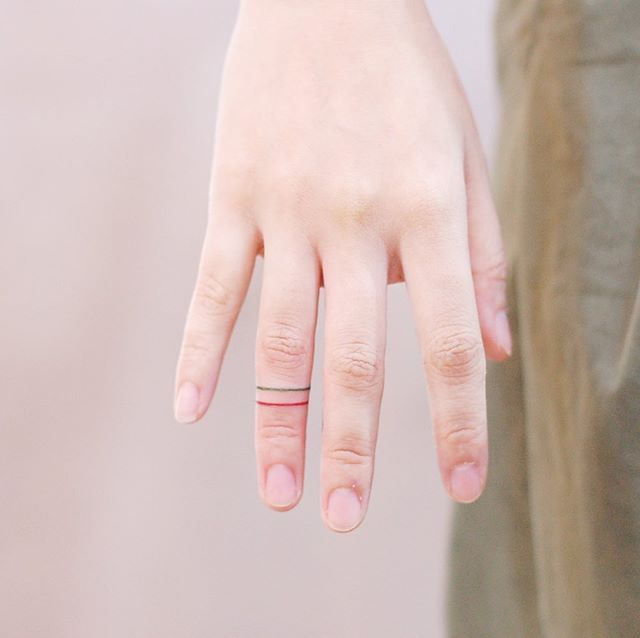 Ring tattoo on finger for women