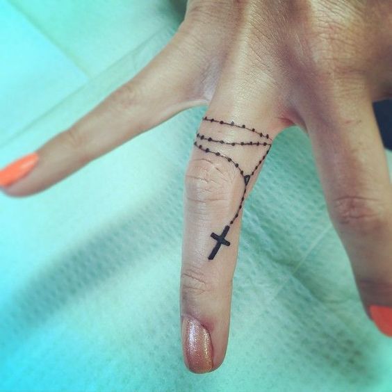 Ring tattoo on finger for women