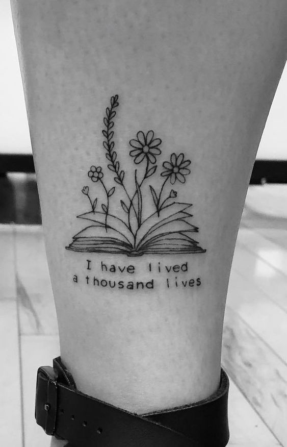 Book tattoo with writing on leg for women