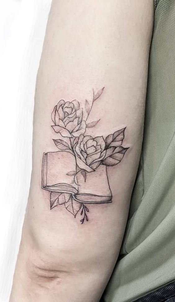 Book and roses tattoo on the shoulder for women