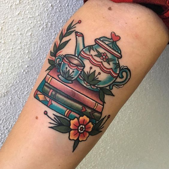 Book and teapot tattoo on the arm for women