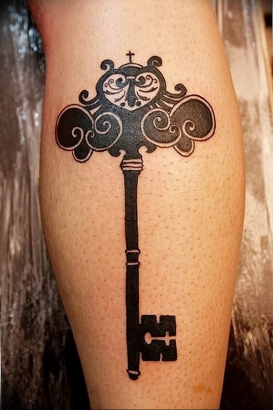 Large key tattoo on the calf for men