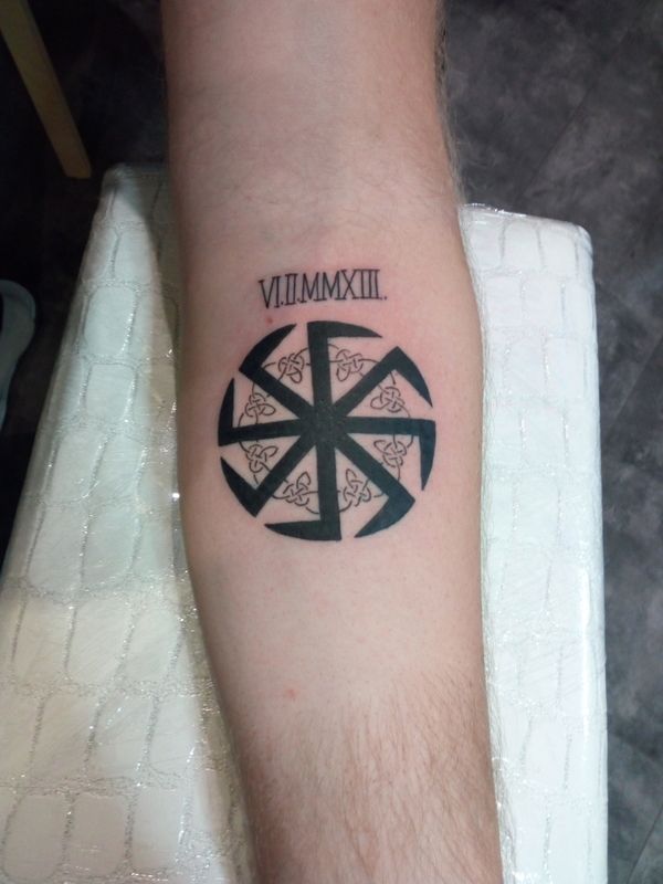 Kolovrat tattoo on the forearm for men