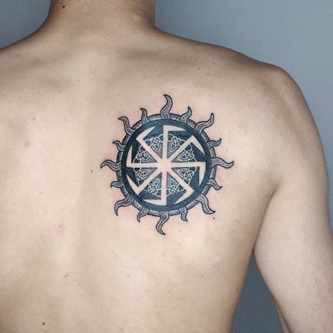 Kolovrat tattoo on shoulder blade for men