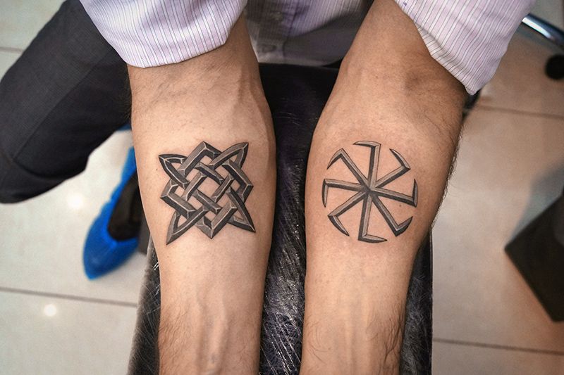 Kolovrat tattoo on the forearm for men