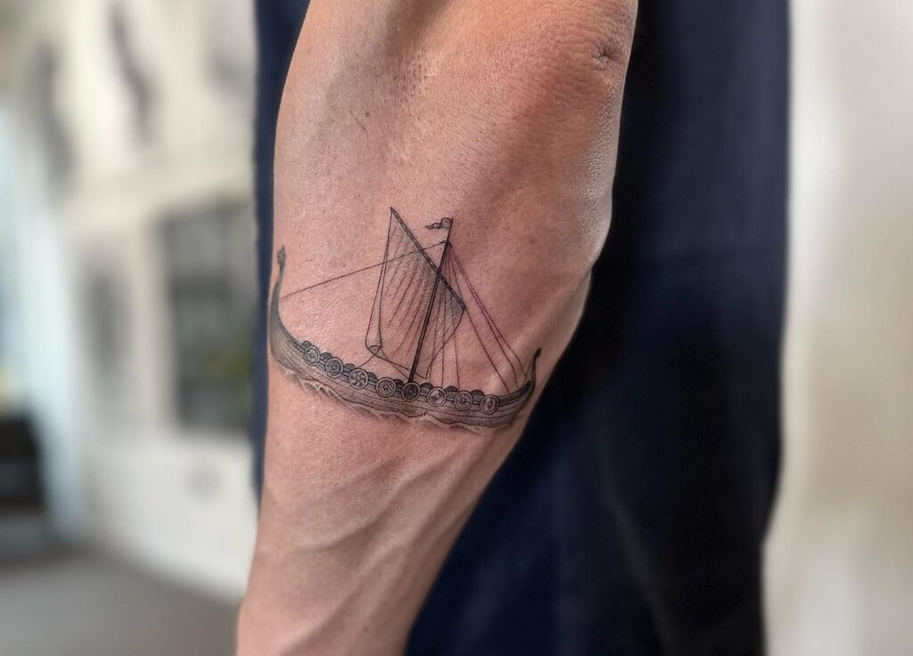 Ship tattoo on forearm for men