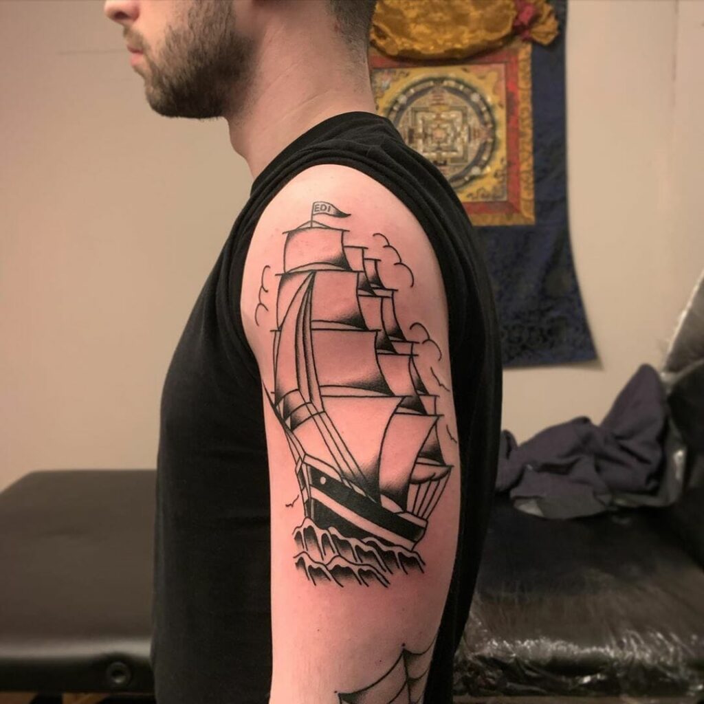 Ship tattoo on the shoulder for men