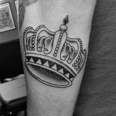 Crown tattoo on the arm for men