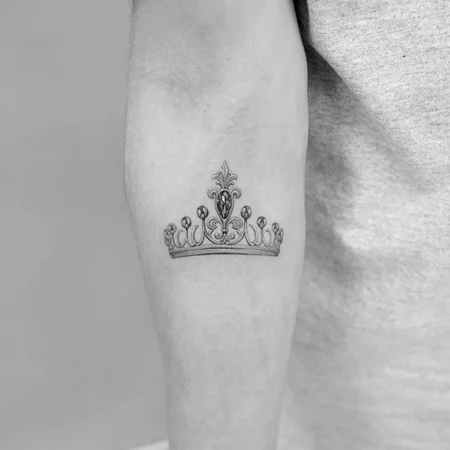 Crown tattoo on forearm for men