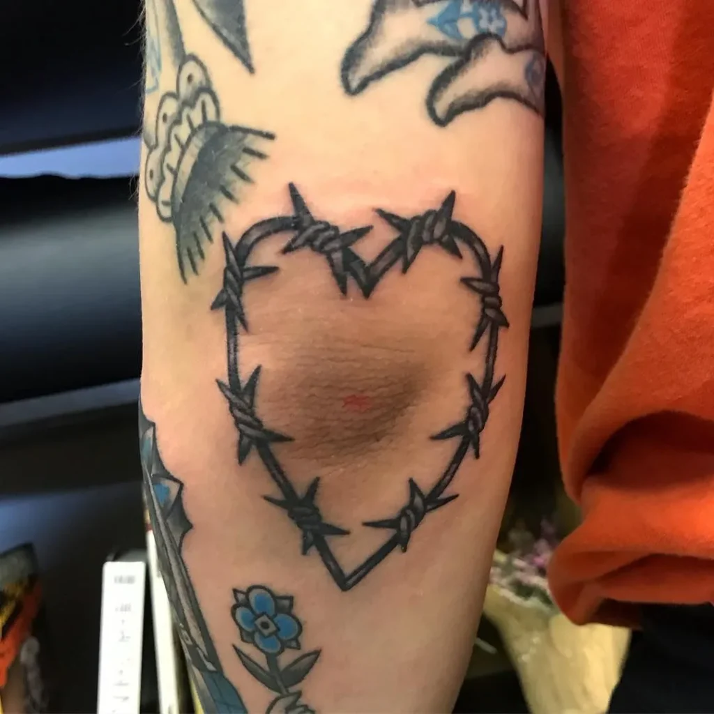 Barbed wire tattoo on elbow for men